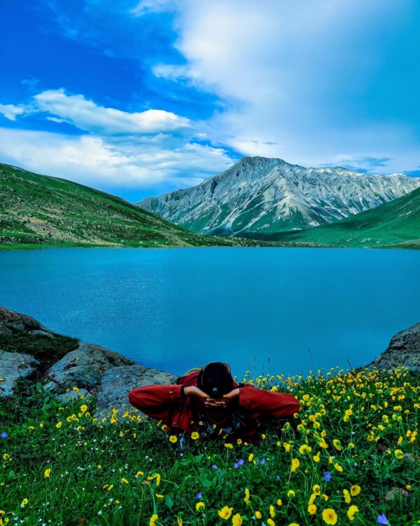 Trekking by an alpine lake